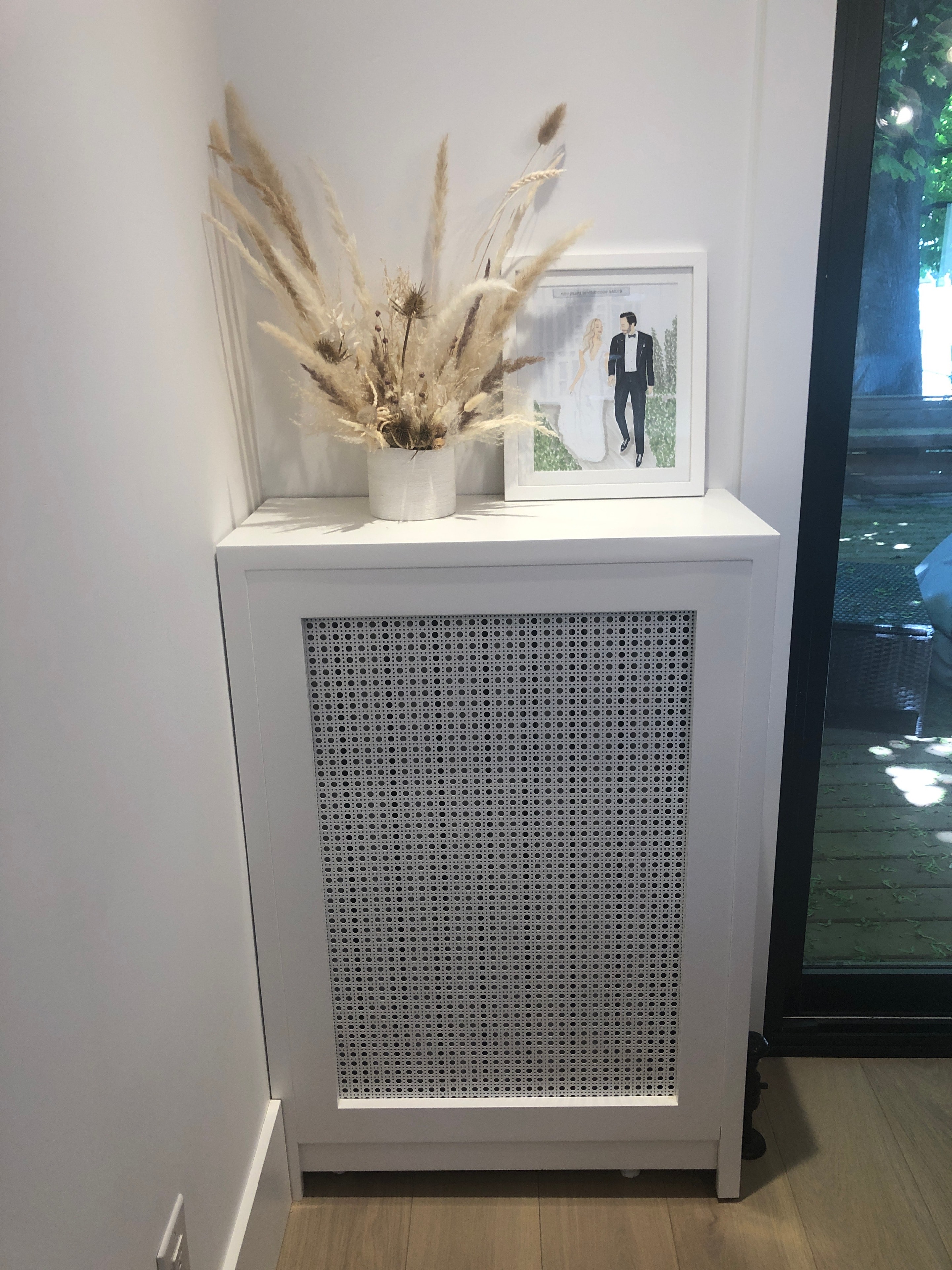 White cabinet with pampas grass